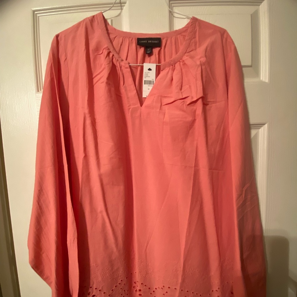 Lane Bryant V-neck blouse. NWT pink/coral in color. Eyelet design at bottom.